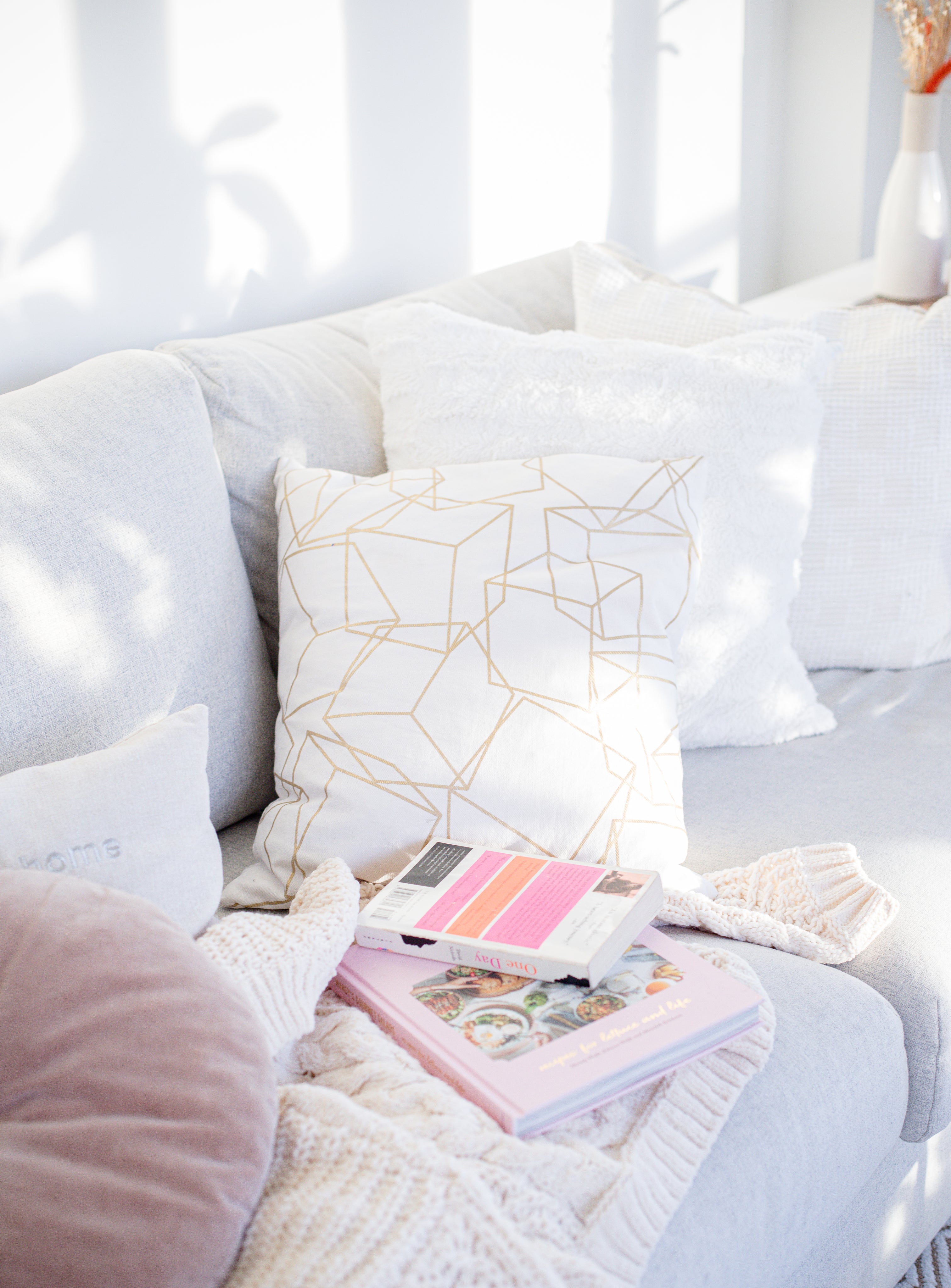 cozy-couch-with-a-blanket-and-books.jpg