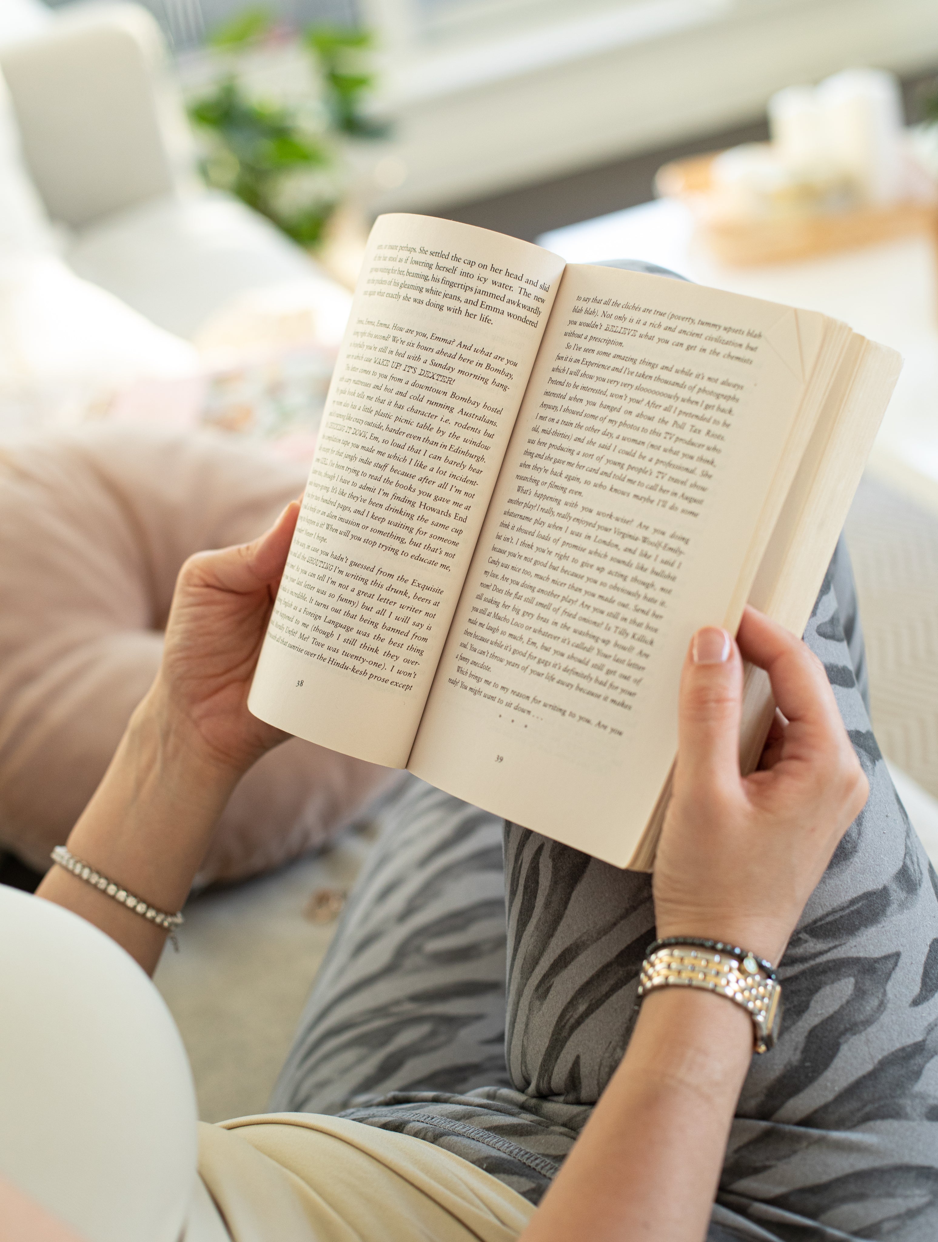 person-holds-a-book-open-against-their-legs.jpg